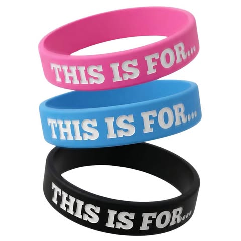 Three This Is For reminder wristbands in pink, blue, and black on a white background