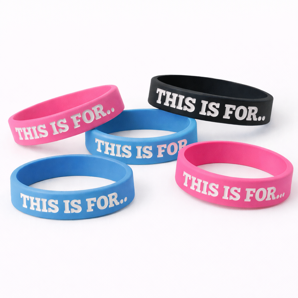 Set of colorful This Is For reminder wristbands in pink, blue, and black on a white background