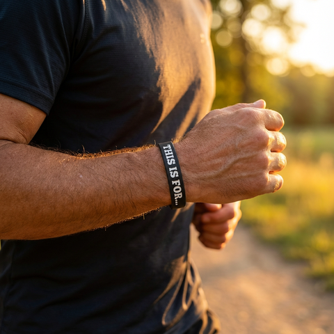 Person running outdoors wearing a This Is For wristband