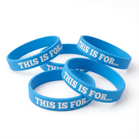 Multiple blue This Is For reminder wristbands on a white background